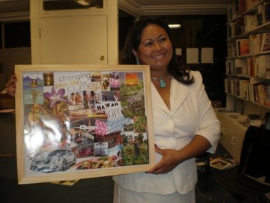 Photo of a lady holding up a collage of her visionboard.